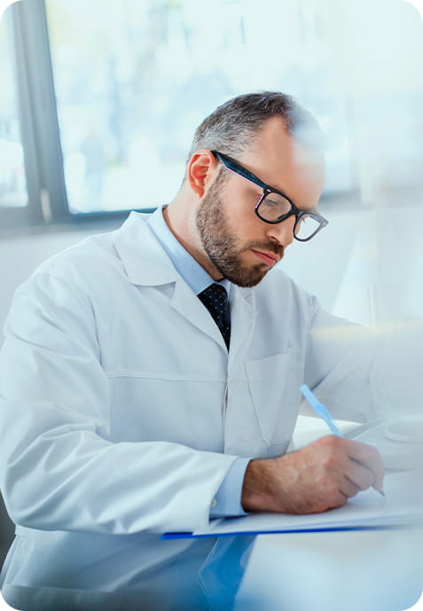 A professional male doctor writing